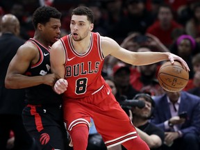 Chicago Bulls guard Zach LaVine, right, drives against Toronto Raptors guard Kyle Lowry during the first half of an NBA basketball game Wednesday, Feb. 14, 2018, in Chicago. The Associated Press