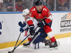 Colton Sceviour of the Florida Panthers and Travis Dermott of the Toronto Maple Leafs battle along the boards at the BB&T Center on February 27, 2018 in Sunrise, Florida. (Joel Auerbach/Getty Images)