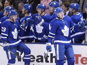 Toronto Maple Leafs defenceman Justin Holl (right) celebrates his first career goal in his first NHL game with teammate Travis Dermott (23) against the New York Islanders during third period NHL hockey action in Toronto on Jan. 31, 2018.  (FRANK GUNN/The Canadian Press)