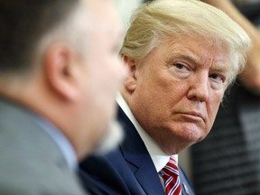 U.S. President Donald Trump listens as Don Bouvet speaks in the Oval Office of the White House, Friday, Feb. 9, 2018, in Washington.