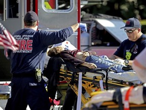 Medical personnel tend to a victim following a shooting at Marjory Stoneman Douglas High School in Parkland, Fla., on Wednesday, Feb. 14, 2018.