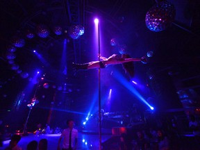 This picture taken on July 2, 2012 shows pole dancing teacher Wang Jing performing at a nightclub in southwest China's Chongqing municipality.