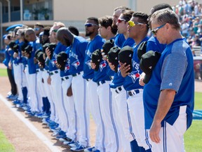 The Toronto Blue Jays pause for a moment of silence for the students of Marjory Stoneman Douglas High and Roy Halladay prior to spring training action against the Philadelphia Phillies in Dunedin on Feb. 23, 2018