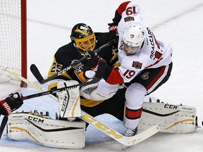 Ottawa Senators forward Derick Brassard (19) collides with Pittsburgh Penguins goalie Marc-Andre Fleury (29) in Pittsburgh on December 5, 2016. (THE CANADIAN PRESS/AP, Gene J. Puskar)