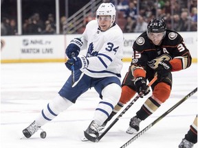 Toronto Maple Leafs centre Auston Matthews, left, controls the puck as Anaheim Ducks right wing Jakob Silfverberg defends during the first period of an NHL hockey game Wednesday, Nov. 1, 2017, in Anaheim, Calif.