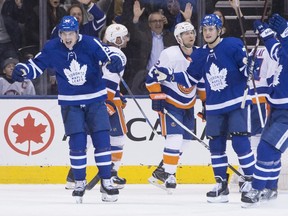 Toronto Maple Leafs' Auston Matthews (left) celebrates after scoring against the New York Islanders during third period NHL hockey action in Toronto, on Thursday, February 22, 2018.THE CANADIAN PRESS/Chris Young