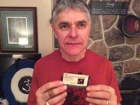Courtice man Greg Bradshaw holds the business card from "Jesus" blasting his parking. (Supplied)