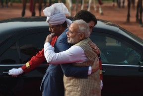 India’s Prime Minister Narendra Modi (R) embraces Canada’s Prime Minister Justin Trudeau (C) during a ceremonial reception at the Presidential Palace in New Delhi on February 23, 2018.