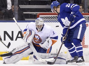 Toronto Maple Leafs right wing Kasperi Kapanen (24) watches the puck in front of New York Islanders goaltender Thomas Greiss (1) during NHL action in Toronto on Wednesday, January 31, 2018. (THE CANADIAN PRESS/Frank Gunn)
