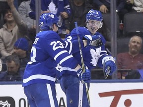 Toronto Maple Leafs, Travis Dermott D (23) congratulates teammate Justin Holl D (3) after he scored his first goal during the third period in Toronto on Thursday February 1, 2018. Jack Boland/Toronto Sun