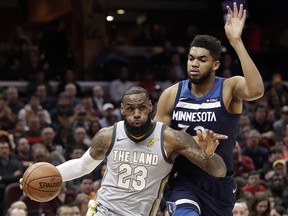 Cleveland Cavaliers star LeBron James, left, drives against Minnesota Timberwolves defender Karl-Anthony Towns Wednesday, Feb. 7, 2018, in Cleveland. (AP Photo/Tony Dejak)