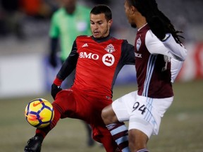 Toronto FC's Sebastian Giovinco, left, moves the ball past Colorado Rapids' Marlon Hairston during the first half of a CONCACAF Champions League soccer match Tuesday, Feb. 20, 2018, in Commerce City, Colo. (AP Photo/David Zalubowski)