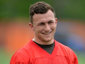 In this May 26, 2015, file photo, then-Cleveland Browns quarterback Johnny Manziel smiles during an NFL football organized team activity, in Berea, Ohio