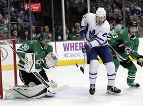 Dallas Stars goaltender Ben Bishop (30) defends as Toronto Maple Leafs left wing James van Riemsdyk (25) deflects a puck toward Bishop as defenseman Esa Lindell (23) of Finland watches in the second period of an NHL hockey game Thursday, Jan. 25, 2018, in Dallas. van Riemsdkyk did not score on the play.