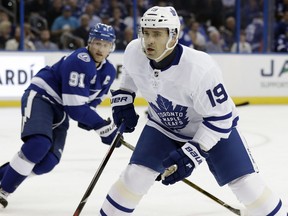 Newly acquired Toronto Maple Leafs centre Tomas Plekanec (19) skates in front of Tampa Bay Lightning center Steven Stamkos (91) during the first period of an NHL hockey game Monday, Feb. 26, 2018, in Tampa, Fla. (AP Photo/Chris O'Meara)
