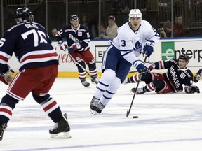Toronto Maple Leafs defenceman Justin Holl (3) controls the puck skating against New York Rangers' Brady Skjei (76) during the third period of an NHL hockey game, Thursday, Feb. 1, 2018, at Madison Square Garden in New York. The Maple Leafs won 4-0. (AP Photo/Mary Altaffer)