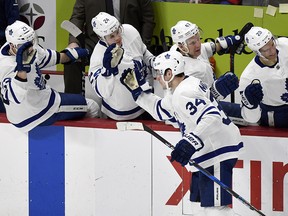 Maple Leafs centre Auston Matthews (34) is congratulated by teammates after scoring against the Detroit Red Wings Sunday, Feb. 18, 2018, in Detroit. (AP Photo/Jose Juarez)