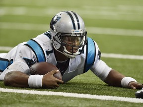 In this Oct. 2, 2016, file photo, Carolina Panthers quarterback Cam Newton (1) lies on the turf after being hit during a game in Atlanta. (AP Photo/Rainier Ehrhardt, File)
