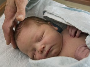 Kateri Schwandt watches her new baby boy at Mercy Health Saint Mary's Campus in Grand Rapids, Mich., Thursday, May 14, 2015.