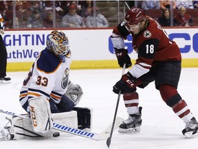 Edmonton Oilers goaltender Cam Talbot (33) makes a save on a shot by Arizona Coyotes center Christian Dvorak (18) on Saturday, Feb. 17, 2018, in Glendale, Ariz.