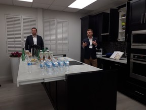Panasonic's Jonathan O'Brien and Jason Disher extol the virtues of new kitchen storage systems. Seen here: A kitchen island with a retractable countertop.