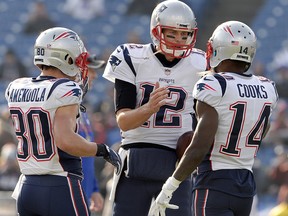 In this Dec. 3, 2017, file photo, New England Patriots quarterback Tom Brady (12) talks with wide receivers Brandin Cooks (14) and Danny Amendola (80) before a game against the Buffalo Bills in Orchard Park, N.Y. (AP Photo/Adrian Kraus, File)