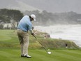 Dallas Cowboys quarterback Tony Romo hits from the 10th tee of the Pebble Beach Golf Links during the AT&T Pebble Beach National Pro-Am golf tournament in Pebble Beach, Calif.
