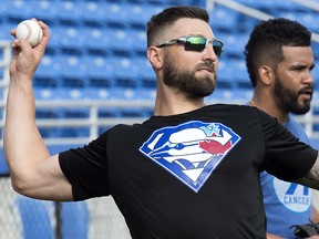 Toronto outfielder Kevin Pillar sports a Blue Jays Superman logo on his shirt while throwing during spring training in Dunedin, Fla., on Tuesday, February 13, 2018. (THE CANADIAN PRESS/Frank Gunn)