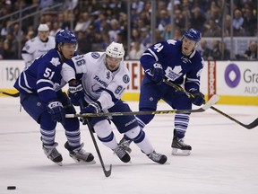 Jake Gardiner  and Morgan Rielly (r) of Toronto against Nikita Kucherov of Tampa as the Maple Leafs face the Tampa Bay Lightning in Toronto on March 30, 2015. Michael Peake/Toronto Sun