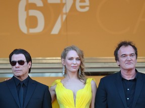 Actors John Travolta and Uma Thurman, and director Quentin Tarantino pose as they arrive for the screening of the film "Sils Maria" at the 67th edition of the Cannes Film Festival in Cannes, southern France, on May 23, 2014. (ALBERTO PIZZOLI/AFP/Getty Images)