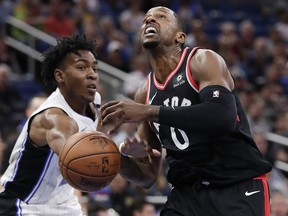 Orlando Magic's Wesley Iwundu, left, knocks the ball out of the hands of Toronto Raptors' CJ Miles as he goes up for a shot Wednesday, Feb. 28, 2018, in Orlando, Fla. (AP Photo/John Raoux)