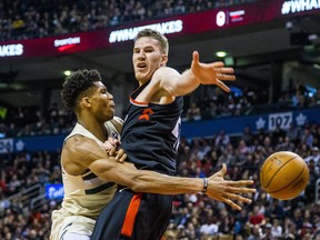Raptors’ Jakob Poeltl (right) tries to block a pass attempt from Bucks star Giannis Antetokounmpo at the ACC on Friday. 
Ernest Doroszuk/Postmedia Network