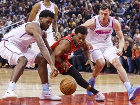 Toronto Raptors guard Kyle Lowry, centre, battles for the ball with Miami Heat Goran Dragic, right, and Justise Winslow in Toronto, Tuesday February 13, 2018. (THE CANADIAN PRESS/Mark Blinch)