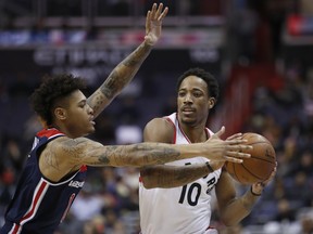 Washington Wizards forward Kelly Oubre Jr., left, guards Toronto Raptors guard DeMar DeRozan during the first half of an NBA basketball game Thursday, Feb. 1, 2018, in Washington. DeRozan can be bothered by Washington's long, lanky defenders. The Associated Press