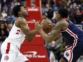 Raptors guard Kyle Lowry, left, and Washington Wizards guard Bradley Beal battle for the ball during their game Thursday, Feb. 1, 2018, in Washington. The Wizards won 122-119. (AP Photo/Alex Brandon) ORG XMIT: VZN109