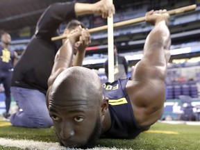 LSU running back Leonard Fournette is tested for flexibility at the NFL football scouting combine Friday, March 3, 2017, in Indianapolis. (AP Photo/David J. Phillip)