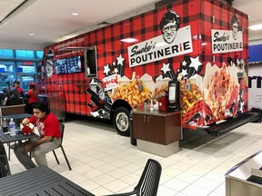 The famous Smoke's Poutinerie food truck greets passengers at Toronto Pearson International Airport's Terminal 3 arrivals department