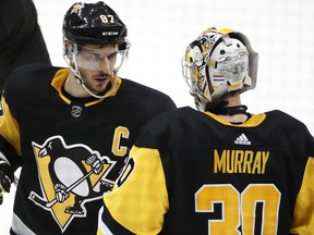 Pittsburgh Penguins' Sidney Crosby (87) celebrates with goaltender Matt Murray (30) after the team's 6-3 win over the Ottawa Senators on Feb. 13, 2018. (GENE J. PUSKAR/AP)