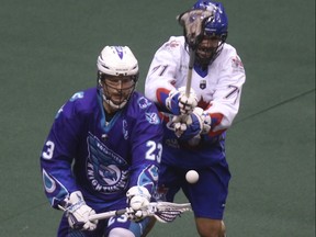 Toronto Rock defender Sheldon Burns (right) swats the ball from the stick of Cory Vitarelli of the Rochester Knighthawks  during the first half in Toronto, Ont. on Jan. 13, 2018. (JACK BOLAND/Toronto Sun)