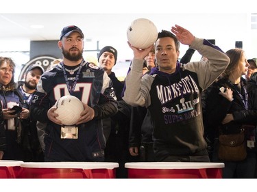 Jimmy Fallon plays beer pong with a New England Patriots fan as he does some taping for "The Tonight Show with Jimmy Fallon," at The StubHub Live: Field House Super Bowl pregame event at Target Field, Sunday, Feb. 4, 2018 in Minneapolis. The event, free for those who purchased tickets to the Super Bowl on StubHub, included food and drink, tailgating games and meet and greets with football greats. (Leila Navidi/Star Tribune via AP) ORG XMIT: MNMIT702
