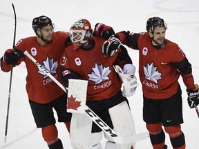 Canada goaltender Kevin Poulin (31), defenceman Marc-Andre Gragnani (18)and forward Rene Bourque (17) celebrate defeating Finland in the Olympic quarterfinal hockey action at the 2018 Olympic Winter Games in Pyeongchang, South Korea on Wednesday, February 21, 2018.