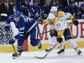 Maple Leafs’ Auston Matthews (left) is chased by the Predators’ Viktor Arvidsson during the first period at the ACC on Wednesday night.