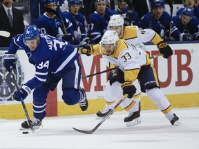 Maple Leafs’ Auston Matthews (left) is chased by the Predators’ Viktor Arvidsson during the first period at the ACC on Wednesday night. (Stan Behal/Toronto Sun)