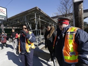 Workers outside Royal York station after a subway shut down closed  due to tampering of the TTC's light system at Royal York in Toronto's west end. Trains resumed service at noon. Friday February 2, 2018. Stan Behal/Toronto Sun/Postmedia Network