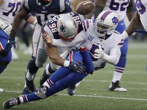 Buffalo Bills quarterback Tyrod Taylor fumbles as he is sacked by New England Patriots defensive end Trey Flowers (98)  Sunday, Dec. 24, 2017, in Foxborough, Mass. (AP Photo/Charles Krupa)
