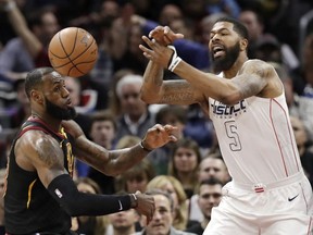 Cleveland Cavaliers' LeBron James, left, and Washington Wizards' Markieff Morris battle for the ball in the first half of an NBA basketball game, Thursday, Feb. 22, 2018, in Cleveland.