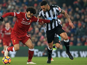 Liverpool's Mohamed Salah vies for the ball with Newcastle United's Jamaal Lascelles. (GETTY IMAGES)
