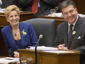Ontario's Premier Kathleen Wynne and Provincial Finance Minister Charles Sousa in the legislature on Wednesday. (THE CANADIAN PRESS)