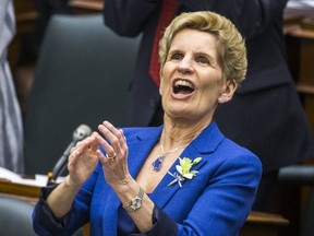 Premier Kathleen Wynne applauds while her government's budget is unveiled in Ontario's legislature. (ERNEST DOROSZUK, Toronto Sun)
