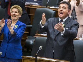 Ontario Finance Minister Charles Sousa delivers the provincial budget at the Ontario Legislature, while Premier Kathleen Wynne looks on. (ERNEST DOROSZUK, Toronto Sun)